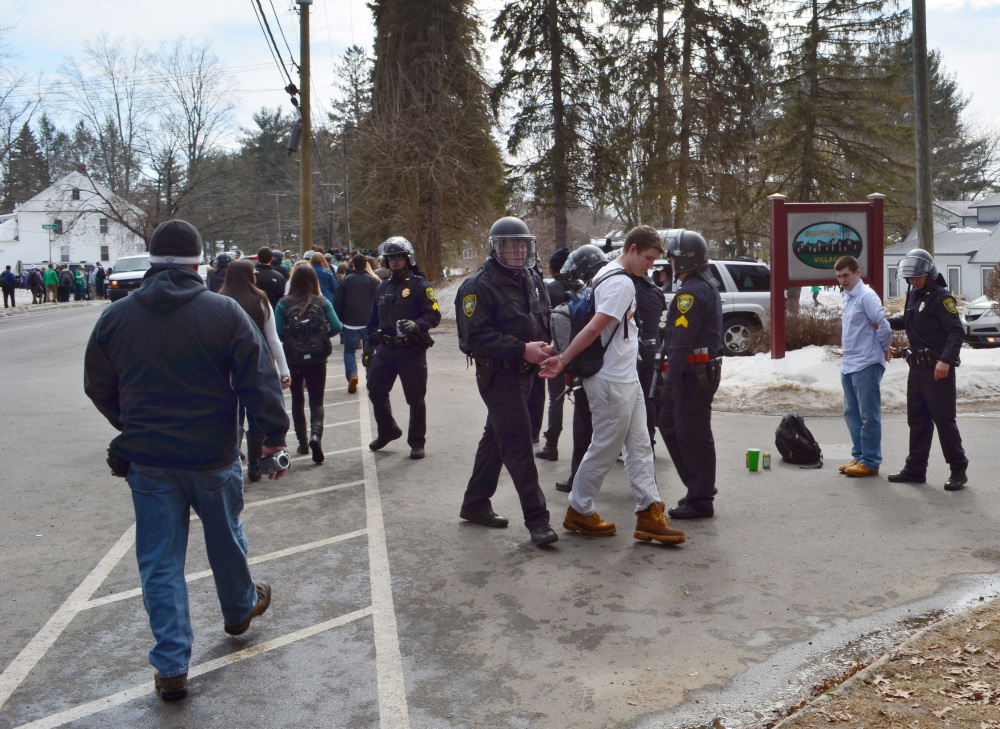 Police detain revelers in the pre-St. Patrick’s Day “Blarney Blowout” near the University of Massachusetts in Amherst, Mass., on Saturday. Police said 73 people were arrested.
