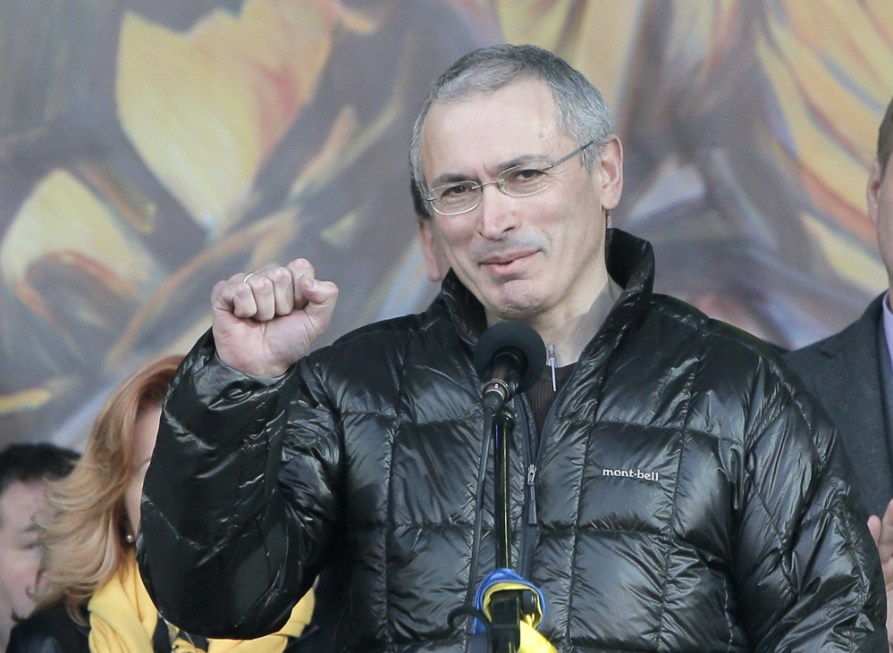 Russian former oil tycoon Mikhail Khodorkovsky cheers people during a rally in the Independence Square in Kiev, Ukraine, Sunday. Khodorkovsky, addressing a crowd on the square where demonstrators rose up against Ukraine’s Moscow-backed president, said Russia had been complicit in police violence against the protesters.