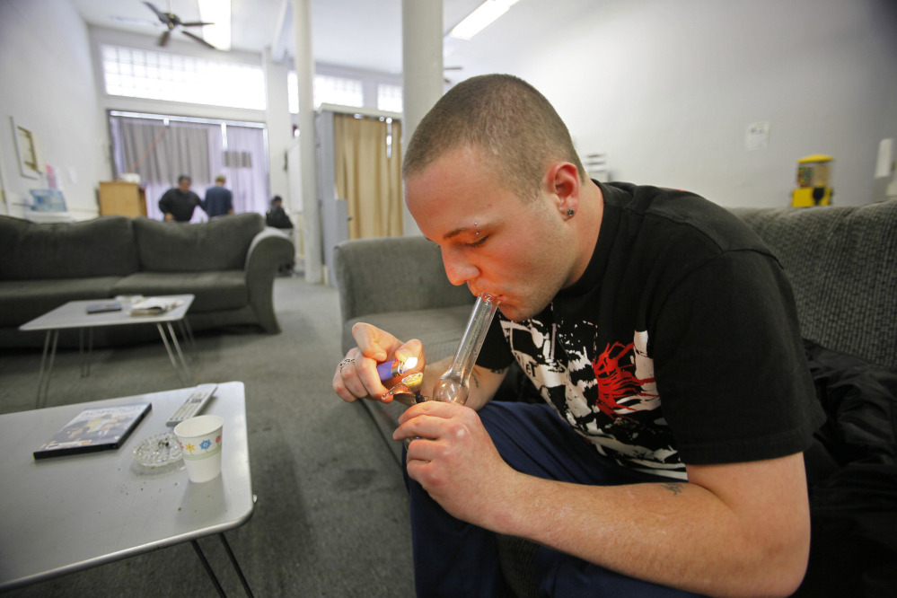 Samuel Bagdorf, who suffers from anxiety disorders, lights a marijuana pipe at the San Francisco Medical Cannabis Clinic. Proposed legislation would provide significant state oversight of the multibillion-dollar industry for the first time.