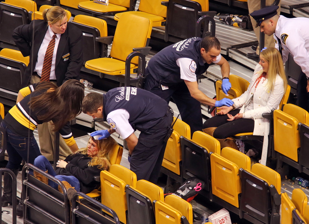Emergency workers attend to injured college students Sabina Grasso and Anna McDonough (in white).