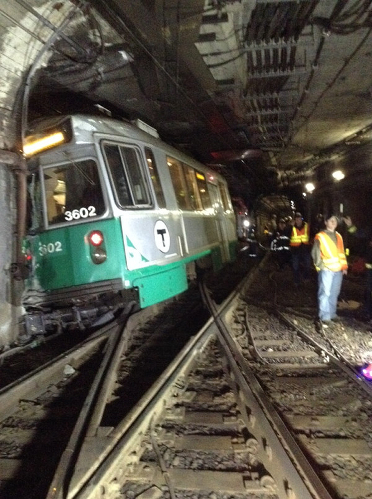 Fire and emergency personnel look over the scene of a MBTA Green Line train derailment in Boston on Monday. Boston Emergency Medical Services report at least seven people, including the derailed train’s driver, complained of back pain. All passengers walked off the train unassisted.