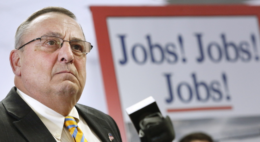 With a backdrop proclaiming his mission, Gov. Paul LePage holds a news conference Monday to roll out his proposed “Open for Business Zones” inside the Maine Technology Institute at Brunswick Landing.