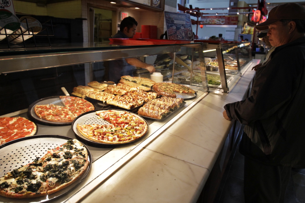 A customer looks at pizzas at a Sbarro restaurant in San Jose, Calif. The pizza and pasta chain says it is filing for bankruptcy reorganization protection after an effort to revitalize the chain’s image with new recipes and ovens apparently didn’t work.