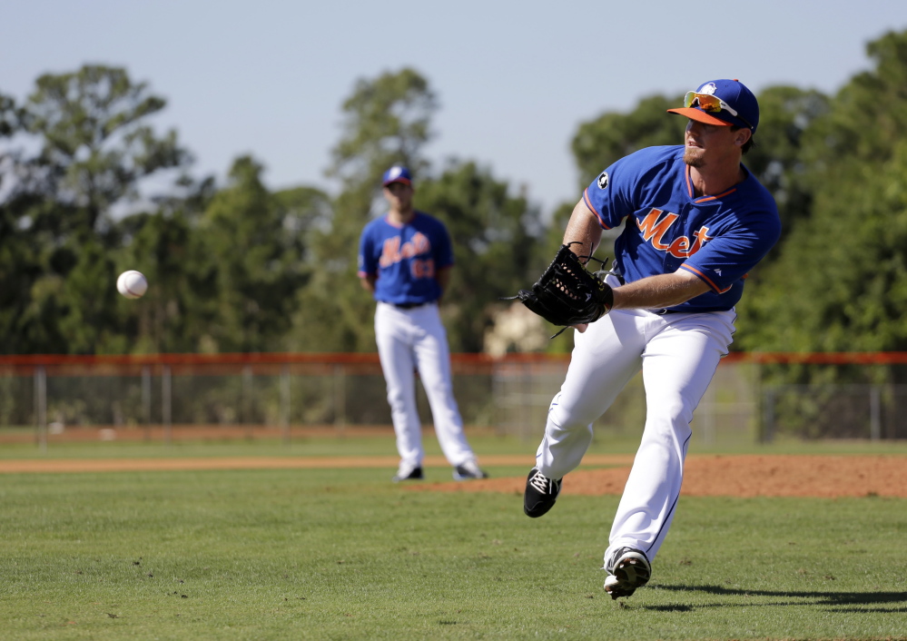New York Mets pitcher Ryan Reid flips a ball home during a drill at spring training practice Feb. 19 in Port St. Lucie, Fla. He has signed with the Marlins for 2015.