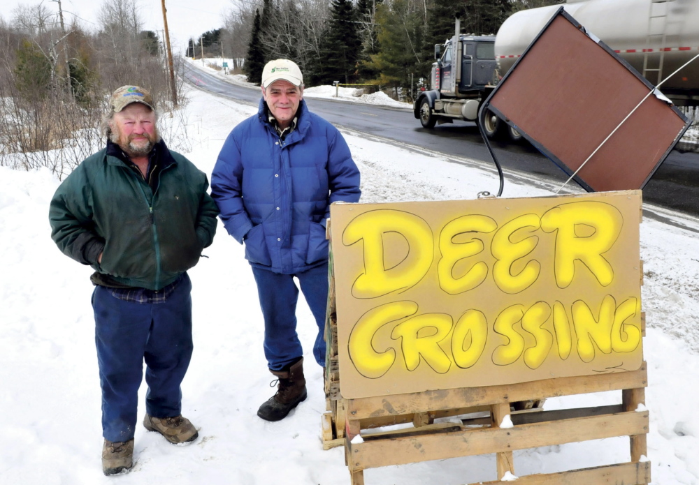 SLOW DOWN: Ed Picard, left, and Lenny Cabral beside a sign that warns motorists that 14 recent collisions with deer have occurred recently along Route 139 near the Unity and Unity Township municipal boundary. “People need to slow down,” Picard said. Cabral added the deer are active because they are hungry.