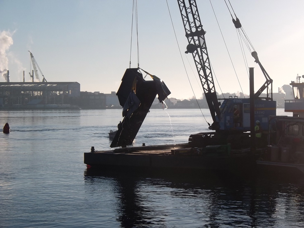 A 10,000-pound section of a fender protection system for the Memorial Bridge is lifted out of the Piscataqua River on Saturday. The panel was torn off when struck by a tanker on Friday. It was floated to the surface with airbags.