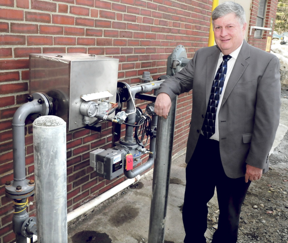 John Dalton, president of Inland Hospital in Waterville, on Monday stands beside a meter where natural gas enters the facility, which has converted to the new energy supply at an estimated annual savings of $100,000.