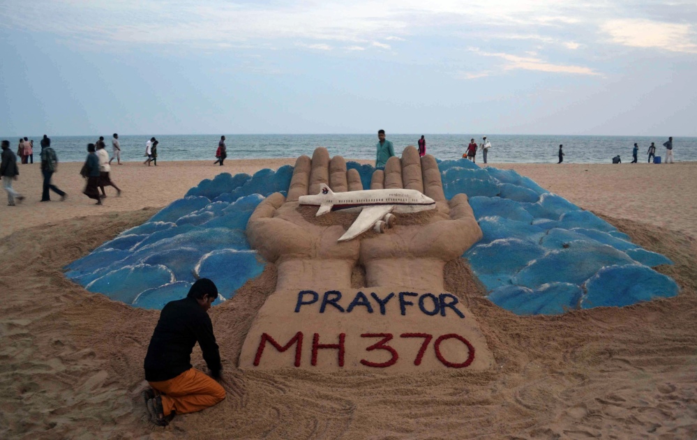 Sand artist Sudarshan Pattnaik creates a sculpture depicting the missing Malaysian Airlines aircraft on the beach in Puri, India, Wednesday, March 12, 2014. Malaysia has asked for India’s assistance in searching for the missing Boeing 777 jetliner to widen the search to an area near the Andaman Sea, an Indian official said Wednesday.