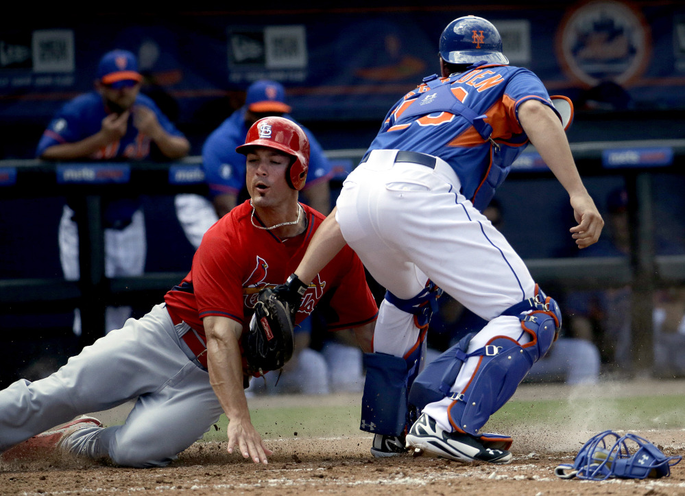Randal Grichuk is tagged out at home by Mets catcher Taylor Teagarden in the fifth inning of an exhibition spring-training game Wednesday at Port St. Lucie, Fla. The Cardinals won, 6-4.