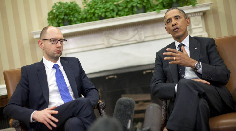 President Obama and Ukraine Prime Minister Arseniy Yatsenyuk meet at the White House on Wednesday. Obama wants Putin to rethink the referendum.