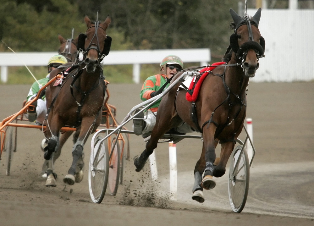 Competitors head down the final stretch during a race in October 2009 at Scarborough Downs. A track official says the two casinos in Maine make it impossible for the Downs to survive without slot machines.