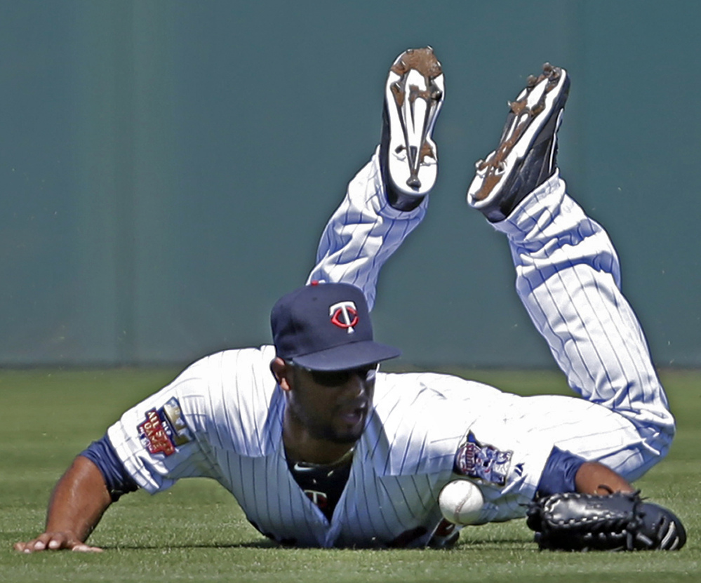 Aaron Hicks, playing center field for the Minnesota Twins, dives but can’t handle a single by Boston’s Mike Napoli in the second inning of a 4-3 exhibition win by the Red Sox at Fort Myers, Fla., on Thursday.