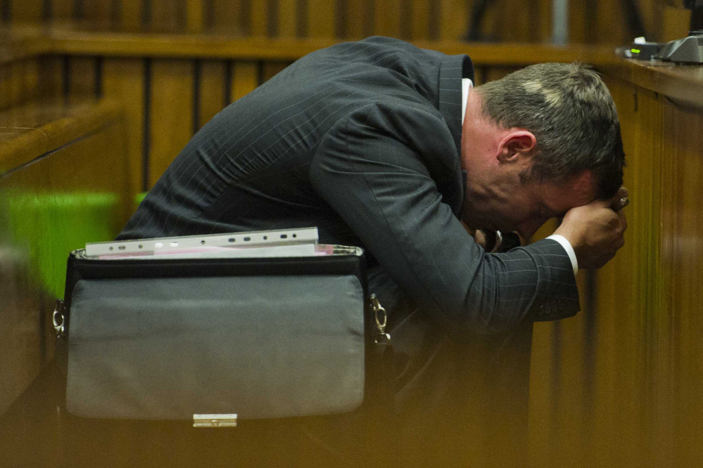 Oscar Pistorius puts his hands to his head as he listens to forensic evidence during his trial in court in Pretoria, South Africa, Thursday. Pistorius is charged with the shooting death of his girlfriend Reeva Steenkamp on Valentines Day in 2013.