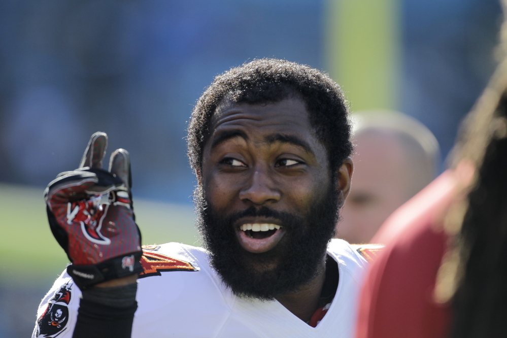 In this file photo, Tampa Bay Buccaneers’ Darrelle Revis clowns around with teammates during warm ups before an NFL football game against the Carolina Panthers. Revis has reportedly agreed to a deal with the New England Patriots.