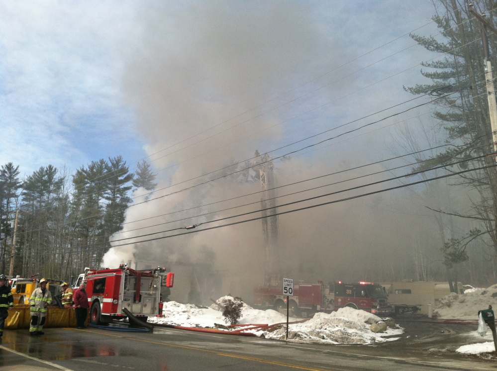 Heavy smoke billows from a house fire on Route 111 iin Arundel on Friday.