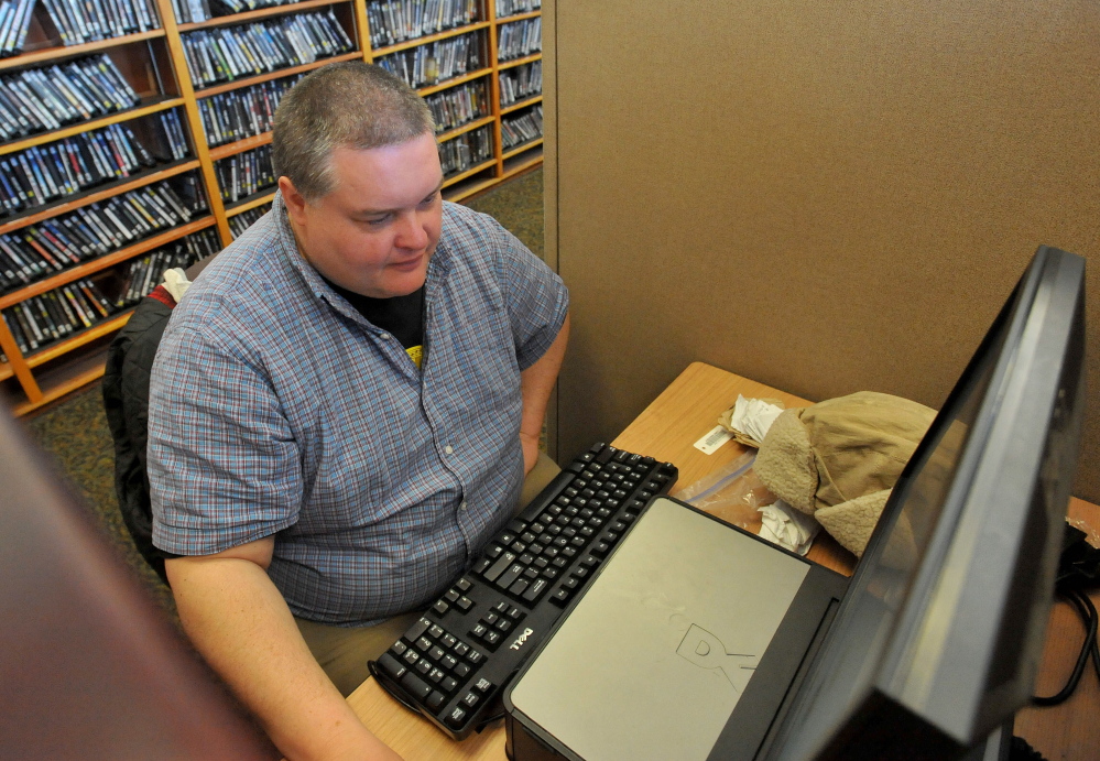 Corey Hewins surfs the Web at the Waterville Public Library on Friday, searching for vacation destinations in California.