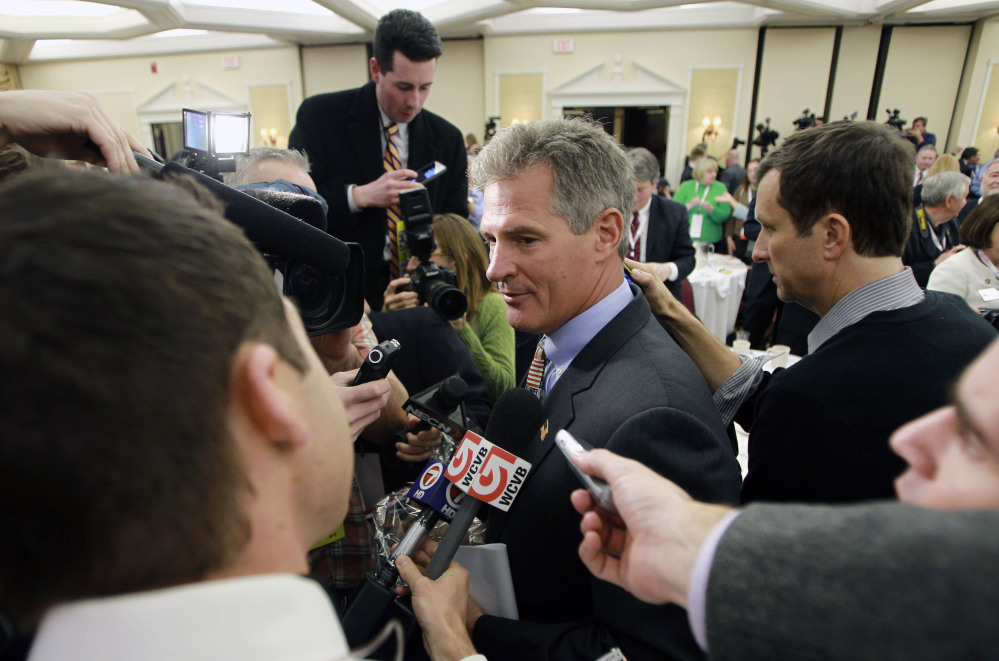 Former Massachusetts Sen. Scott Brown, center, leaves the ballroom at the Republican Leadership Conference after announcing plans to form an exploratory committee to enter New Hampshire’s U.S. Senate race against Democratic Sen. Jeanne Shaheen on Friday in Nashua, N.H.