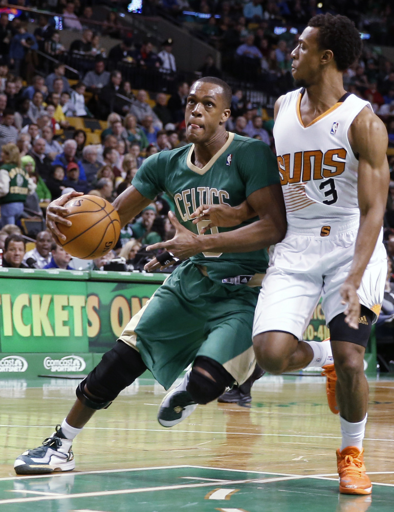 Boston’s Rajon Rondo drives on Phoenix’s Ish Smith during the first quarter of Friday night’s game in Boston, won by the Suns.