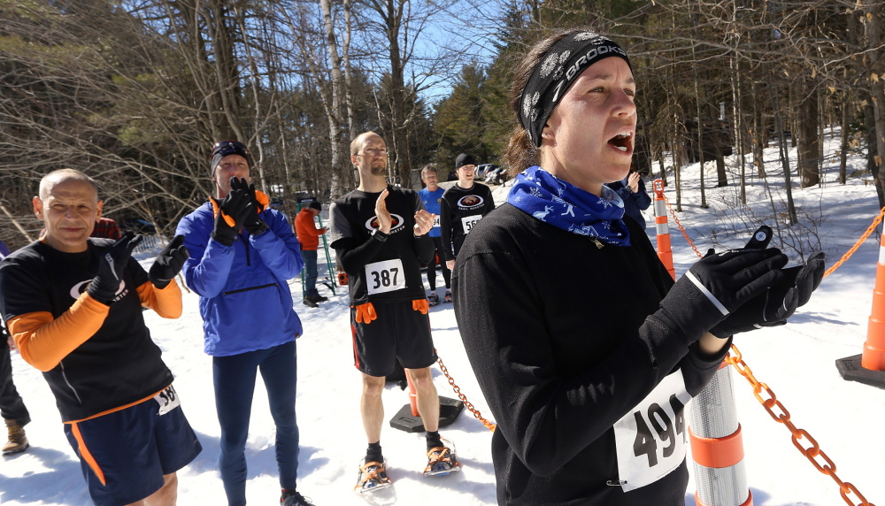 Saco’s Rebecca Miller cheers on her fellow Trail Monsters at the finish line at Bradbury Mountain State Park, scene of snowshoe and trail running races – all of which require monstrous grit.