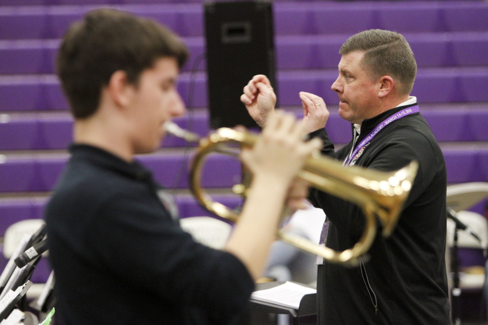 South Portland High School jazz band director Craig Skeffington conducts the group as Alex Quinn performs a solo on the flugelhorn.