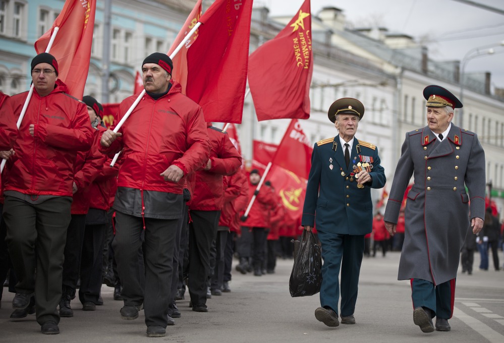 Demonstrators wearing red and two WWII veterans, right, march in support of Kremlin-backed plans for the Ukrainian province of Crimea to break away and merge with Russia, in Moscow on Saturday.
