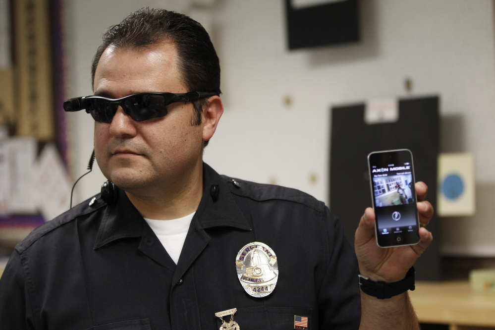 Los Angeles police Sgt. Daniel Gomez shows a video feed from a camera into his cellphone. Without strong policies on body cameras, departments could lose the public’s trust.