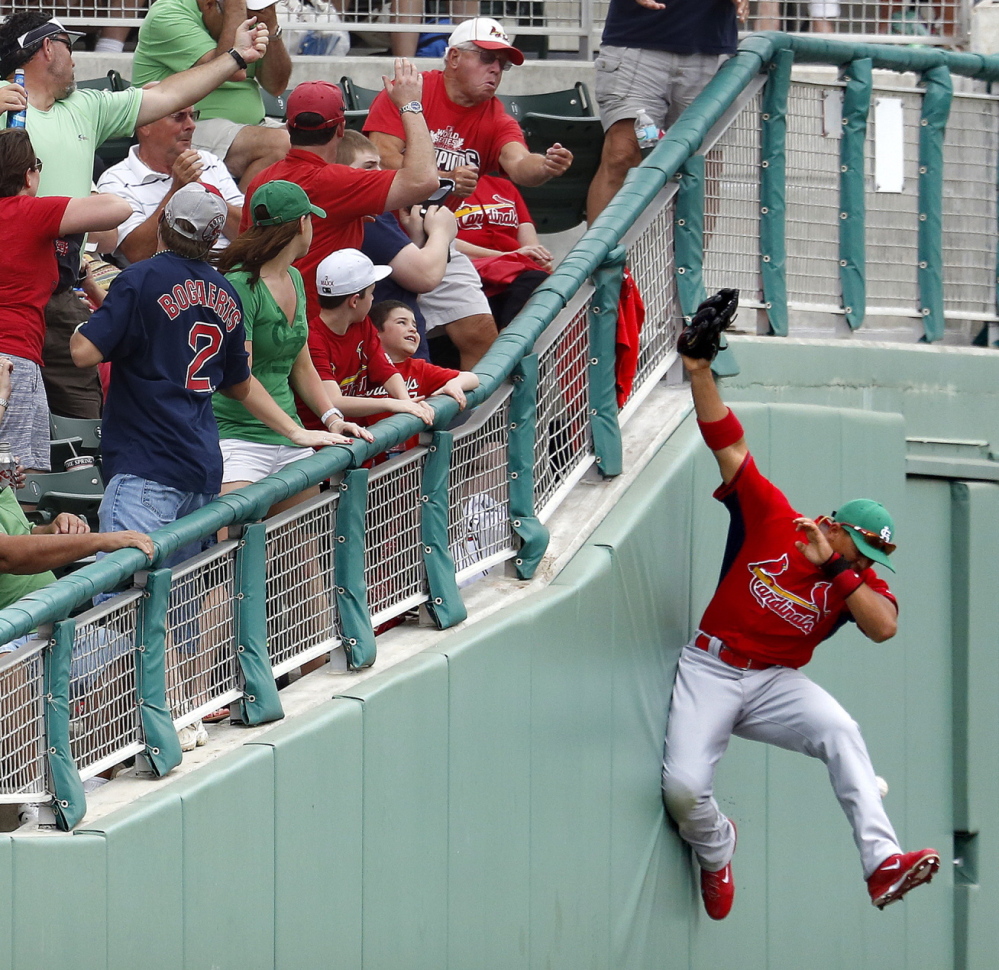 It’s a near-miss for St. Louis outfielder John Jay, whose valiant effort to snag a foul ball was for naught during Monday’s exhibition game against the Red Sox in Fort Myers, Fla.