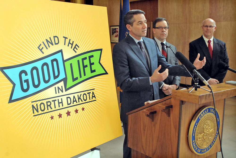 North Dakota Lt. Gov. Drew Wrigley, left, along with Wally Goulet, center, of the North Dakota Economic Foundation, and Steve McNally, general manager of Hess Corp. in North Dakota, answer questions about the “Find The Good Life In North Dakota” campaign unveiled Monday in Bismarck, N.D.