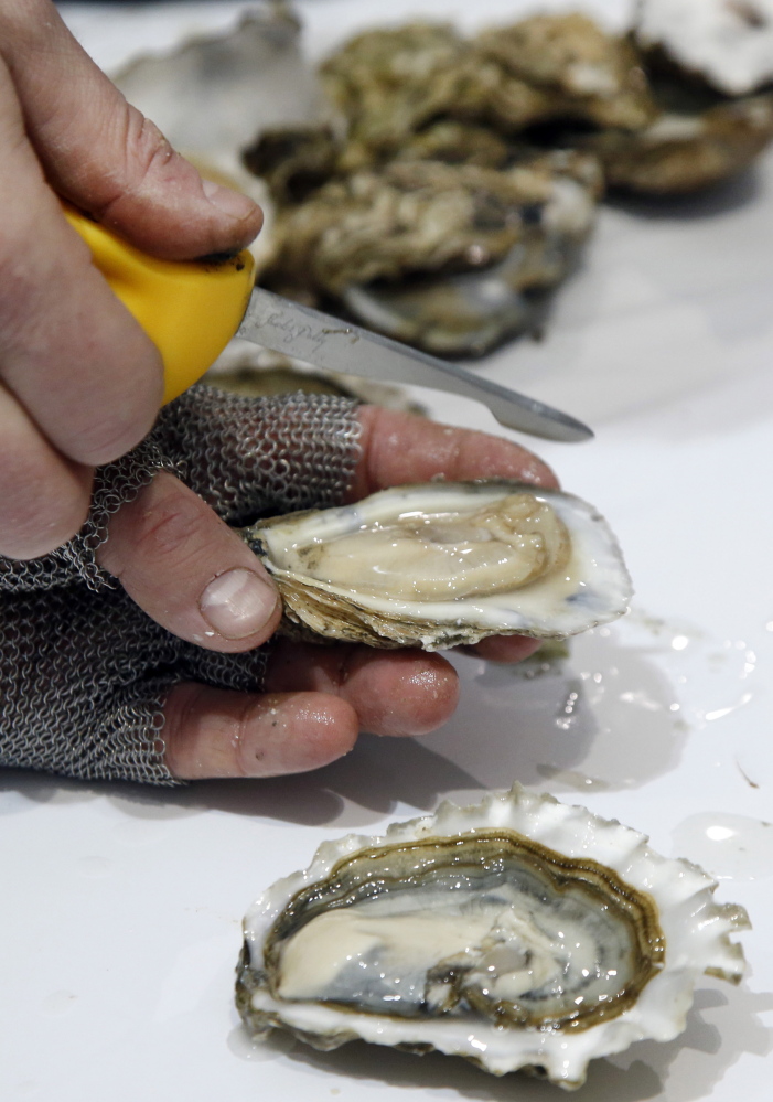 Patrick McMurray, owner of Starfish Oyster Bed & Grill of Toronto, Canada, shows off his oyster shucking skill.