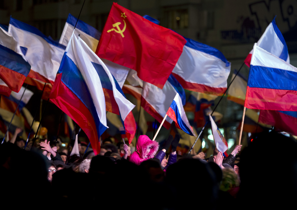 Pro-Russian people celebrate in Lenin Square, in Simferopol, Ukraine, on Sunday. Fireworks exploded and Russian flags fluttered above jubilant crowds after residents in Crimea voted overwhelmingly to secede from Ukraine and join Russia.