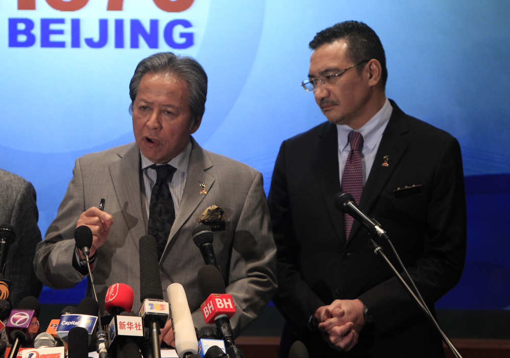 Malaysian Foreign Minister Anifah Aman, left, speaks as Malaysian acting Transport Minister Hishammuddin Hussein listens during a press conference at a hotel in Sepang, Malaysia Tuesday, March 18. Checks into the background of all the Chinese nationals on board the missing Malaysian jetliner have uncovered no links to terrorism, the Chinese ambassador in Kuala Lumpur said.