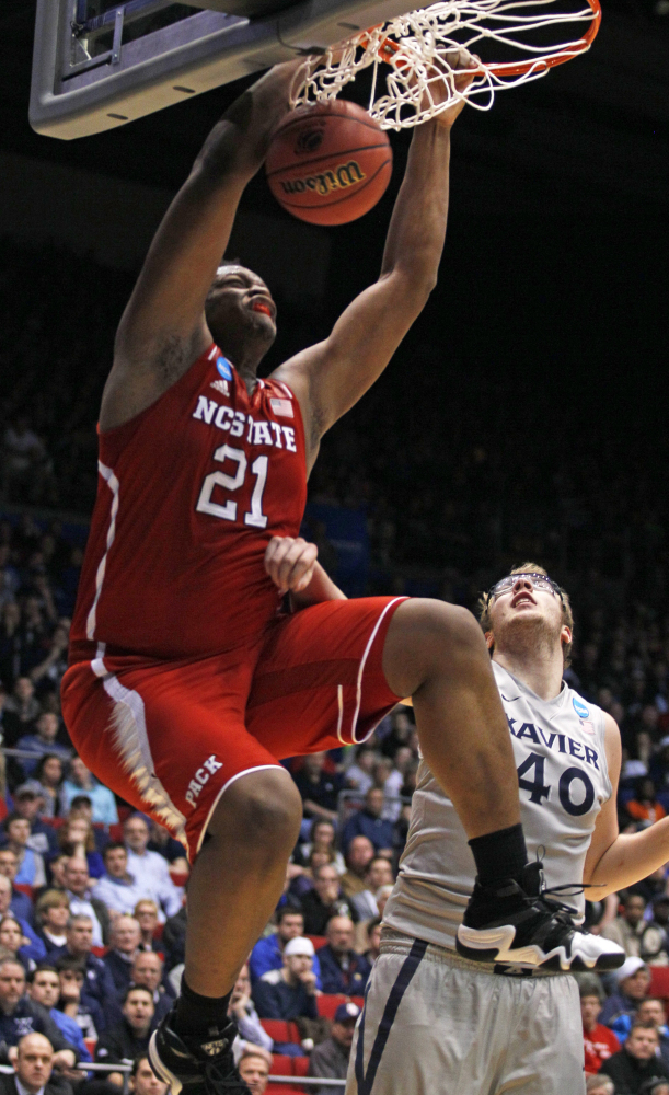 North Carolina State’s Beejay Anya dunks against Xavier’s Matt Stainbrook during the Wolfpack’s NCAA win Tuesday at Dayton, Ohio.