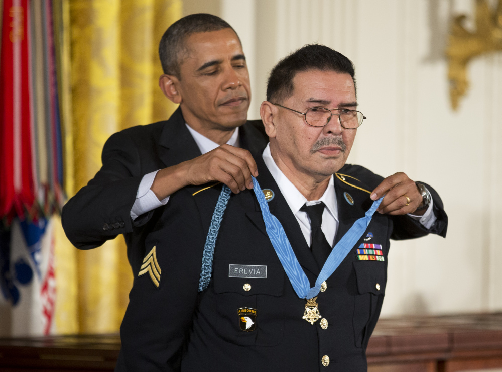 President Barack Obama awards Army Spc. Santiago Erevia the Medal of Honor during a ceremony in the East Room of the White House in Washington, Tuesday, March 18, 2014.