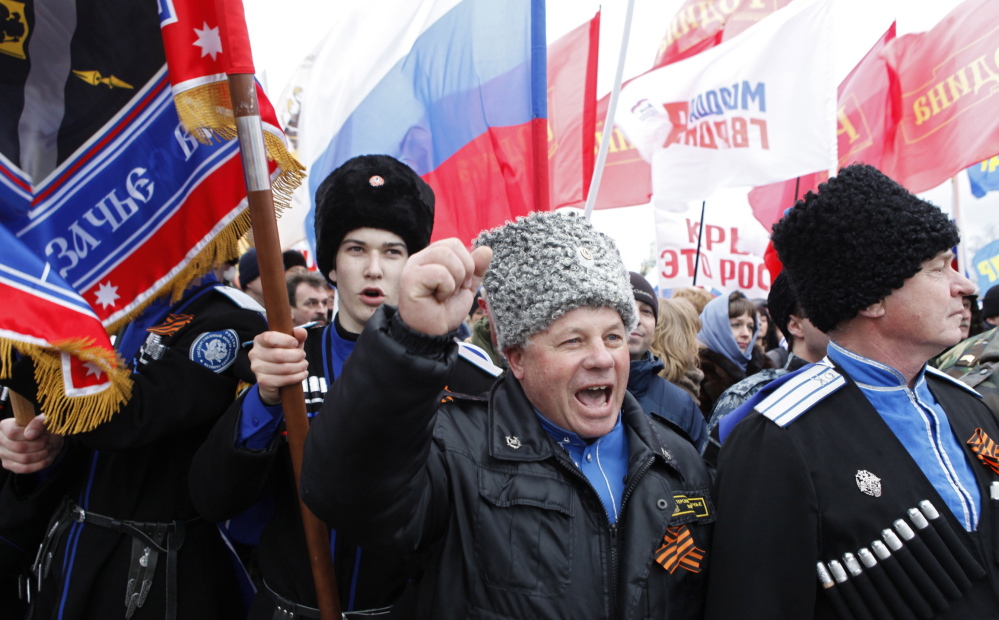 While Ukrainians struggle to come to grips with an uncertain political landscape, many of their former countrymen in Crimea are celebrating. Here, a group of Cossacks attend a rally to support the annexation of Ukraine’s Crimea to Russia in the southern Russian city of Stavropol on Tuesday. Tensions remain high in the region after a military attack Tuesday.