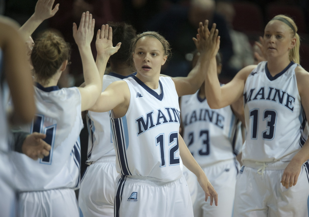 Wednesday was a night for sharing the ball and sharing the love as the University of Maine earned its second postseason victory in its women’s basketball history, defeating Bucknell, 77-47. Rachele Burns, 12, congratulates her teammates after the game at the Cross Insurance Center.