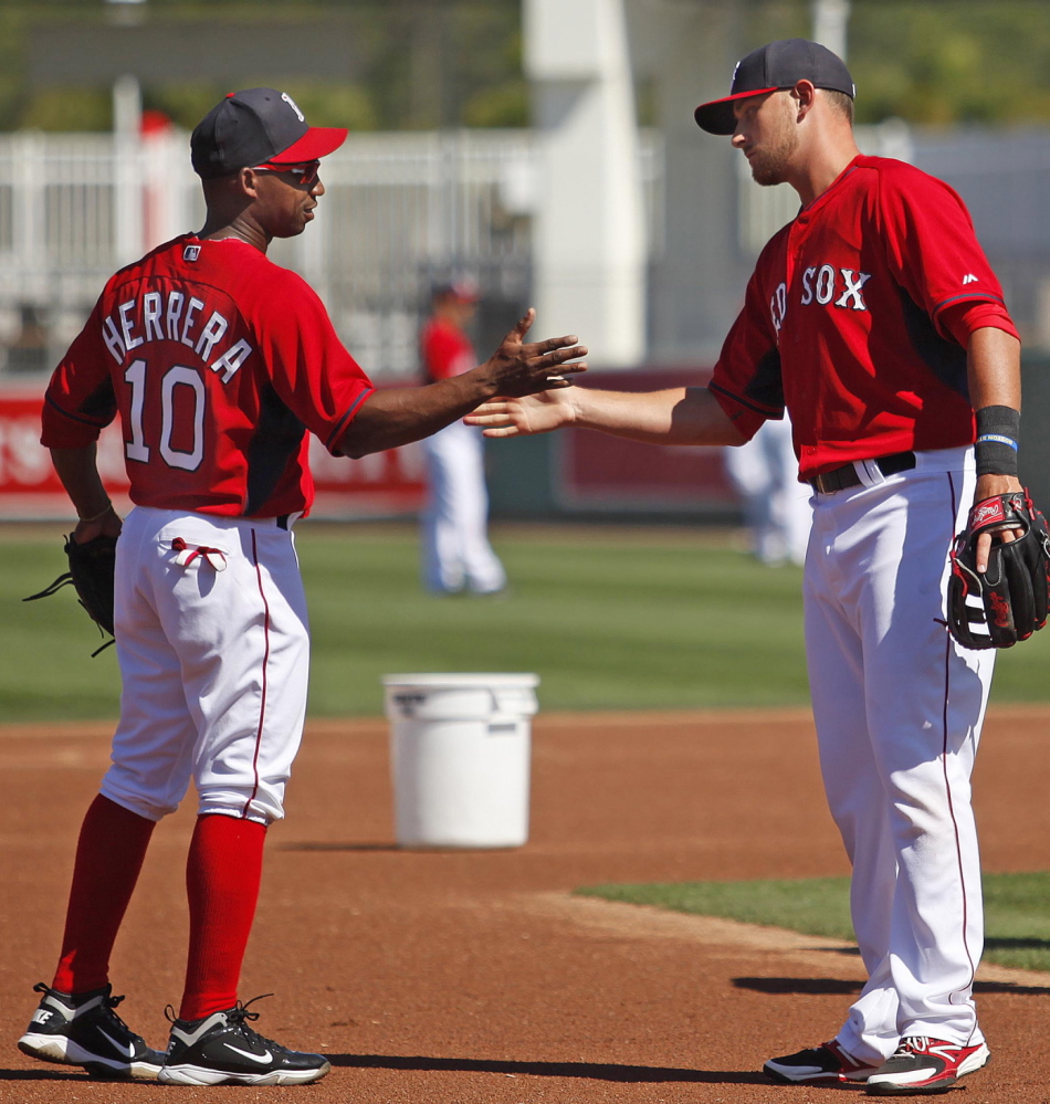 It’s not just about pitching, hitting, defense and baserunning. Spring training is a time to work on that handshake. Jonathan Herrera and Will Middlebrooks get in their work.