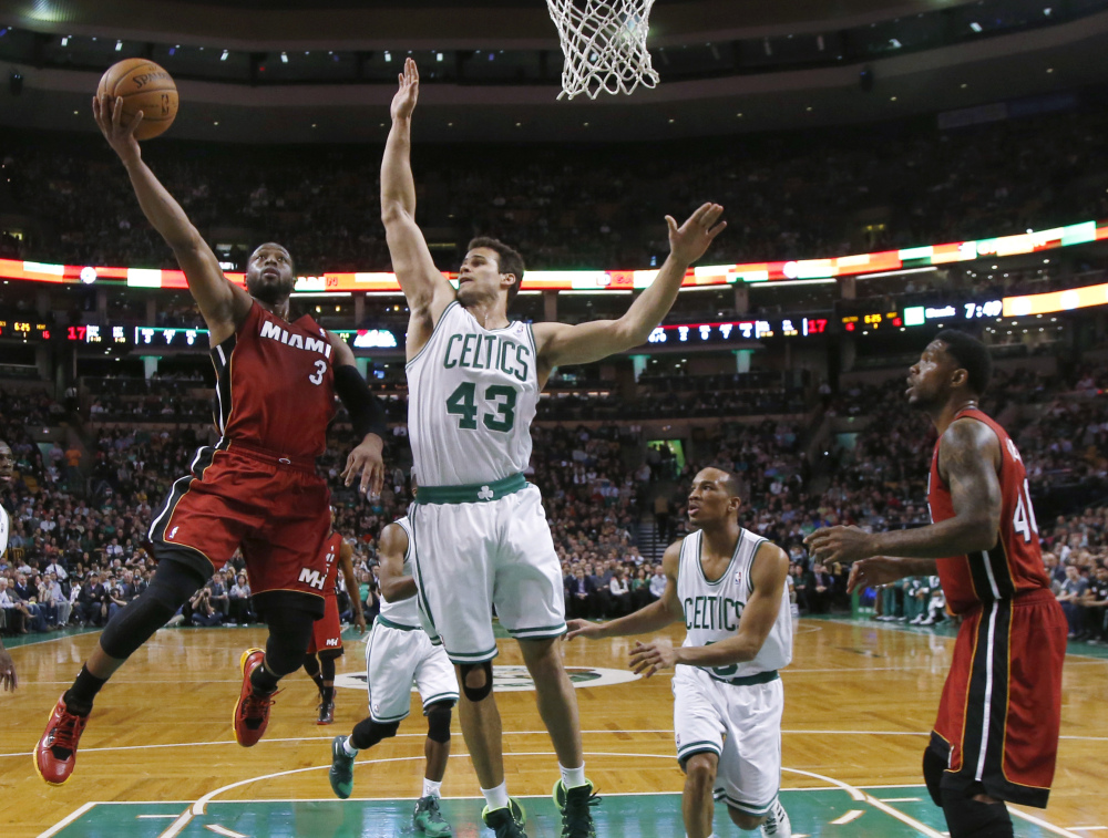Miami Heat guard Dwyane Wade drives to the basket against Boston Celtics center Kris Humphries in the first quarter Wednesday in Boston.