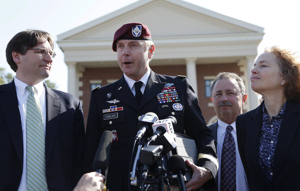 Brig. Gen. Jeffrey Sinclair, who admitted to inappropriate relationships with three subordinates, makes a statement after leaving the courthouse following sentencing at Fort Bragg, N.C., Thursday. Attorneys Lathrop Nelson III, left, Richard Scheff and Ellen Brotman accompany him.