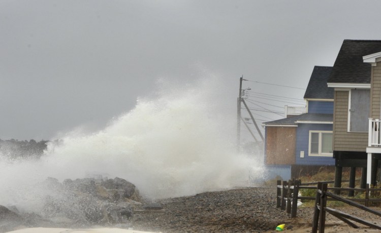 A wave comes over a sea wall in Saco  at high tide during Superstorm Sandy in October 2012. 