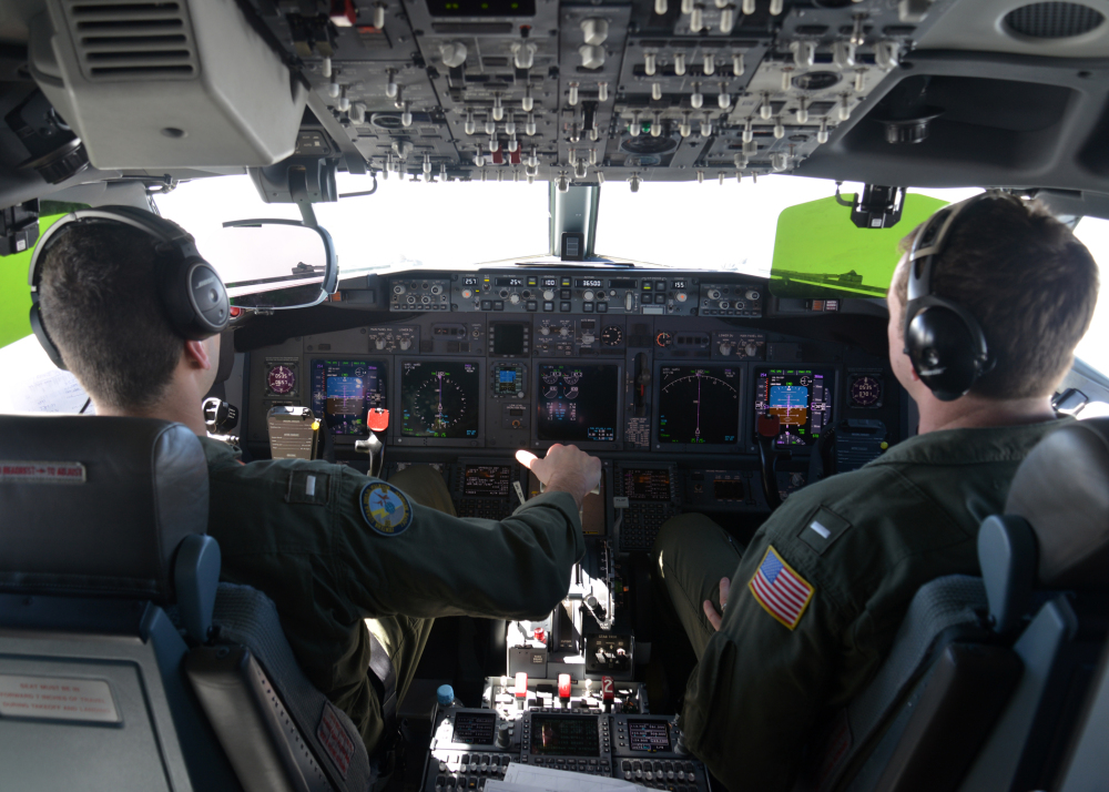 In this photo provided by the U.S. Navy, Lt. j.g. Kyle Atakturk, left, and Lt. j.g. Nicholas Horton pilot a U.S. Navy P-8A Poseidon during a mission to assist in search and rescue operations for Malaysia Airlines flight MH370 on Wednesday. Military planes from Australia, the U.S. and New Zealand have been searching for the plane in a region over the southern Indian Ocean that was narrowed down from 232,000 square miles to 117,000 square miles.