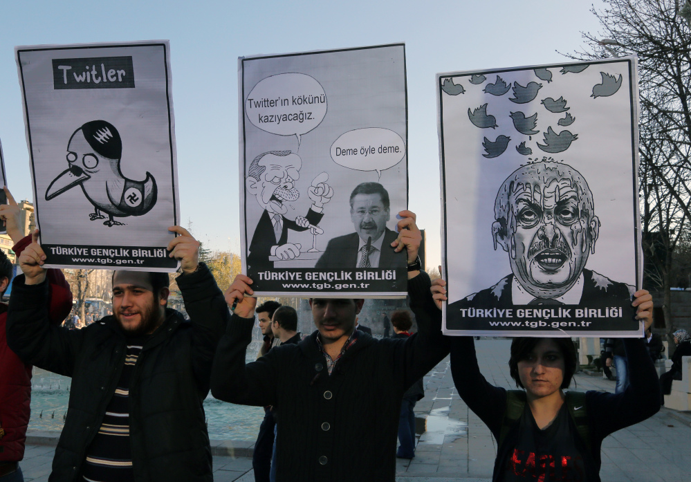 Members of the Turkish Youth Union hold cartoons depicting Prime Minister Recep Tayyip Erdogan during a protest against a ban on Twitter in Ankara, Turkey, on Friday.