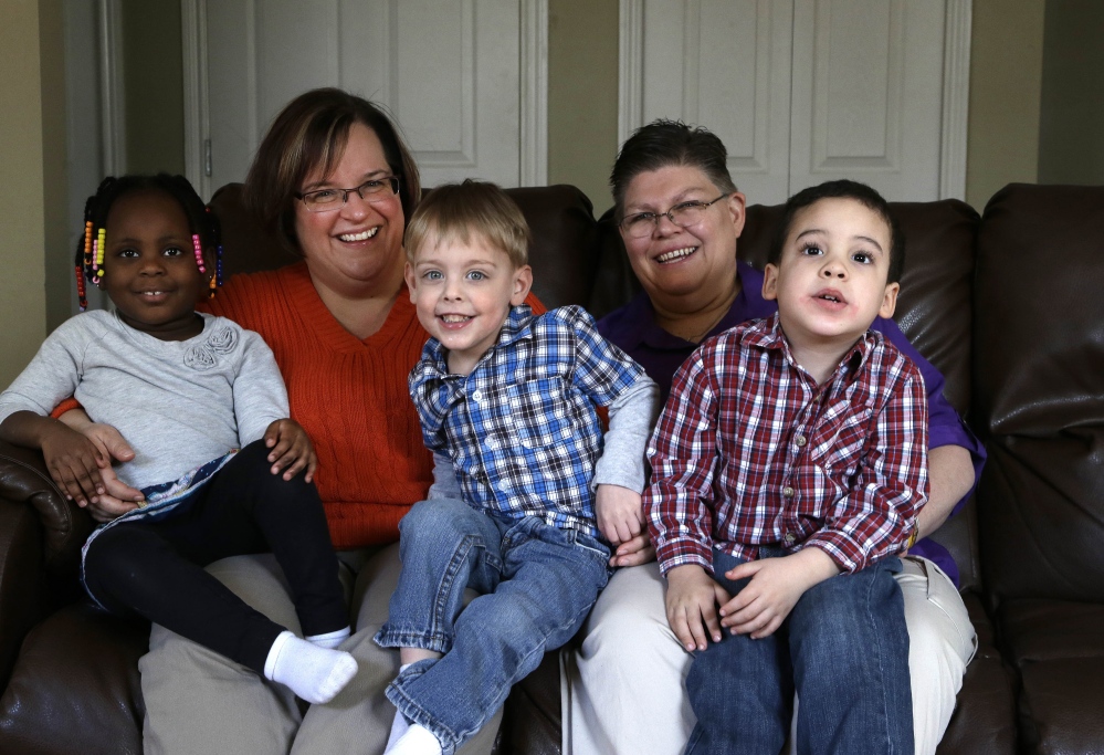 April DeBoer, second from left, and Jayne Rowse, second from right, sit with their adopted children at their home in Hazel Park, Mich. The two nurses who’ve been partners for eight years claimed Michigan’s gay marriage ban violated their rights under the U.S. Constitution.