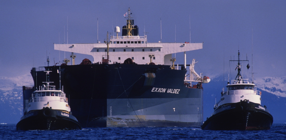 The Exxon Valdez is towed away from Bligh Reef in Alaska’s Prince William Sound. Monday marks 25 years since the ship spilled 11 million gallons of oil.