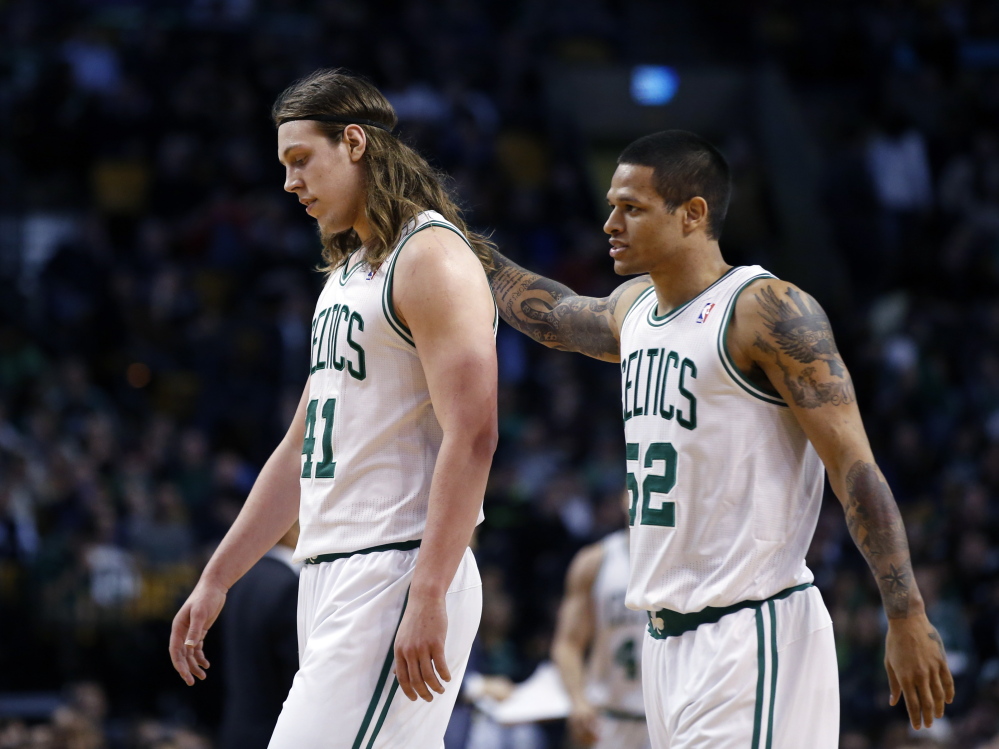 Boston Celtics center Kelly Olynyk, left, and guard Chris Babb walk to the bench during a time out in the fourth quarter of a March 5 game against the Golden State Warriors in Boston. The Warriors won 108-88.