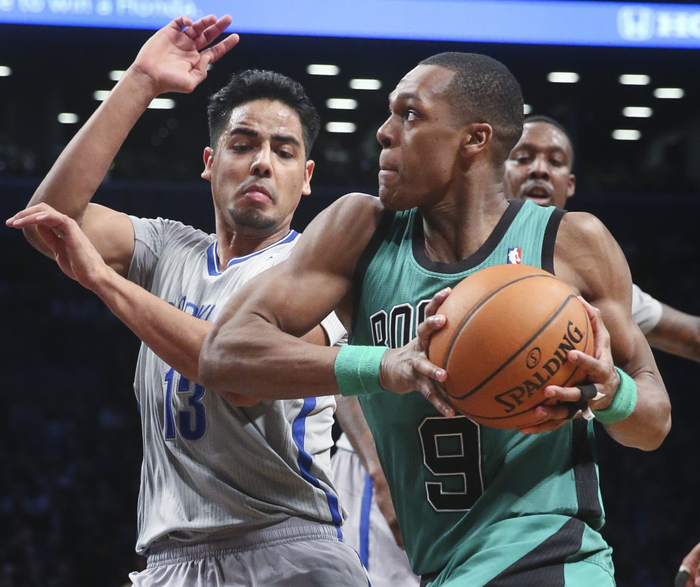 Boston’s Rajon Rondo drives against Brooklyn’s Jorge Gutierrez during second-half action of Friday’s game in New York, a 114-98 win by the Nets.