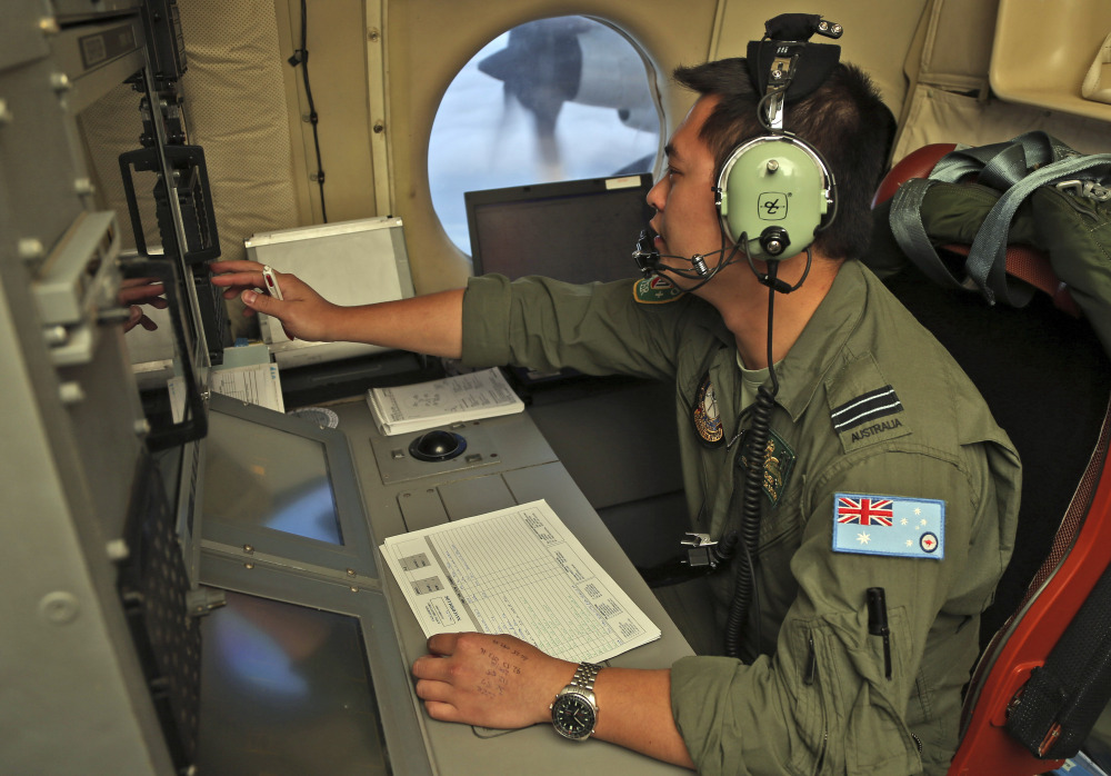 Flight Officer Jack Chen mans the navigation and communication station on board a Royal Australian Air Force AP-3C Orion as they search for missing Malaysia Airlines flight MH370 in southern Indian Ocean, Australia, on Saturday.