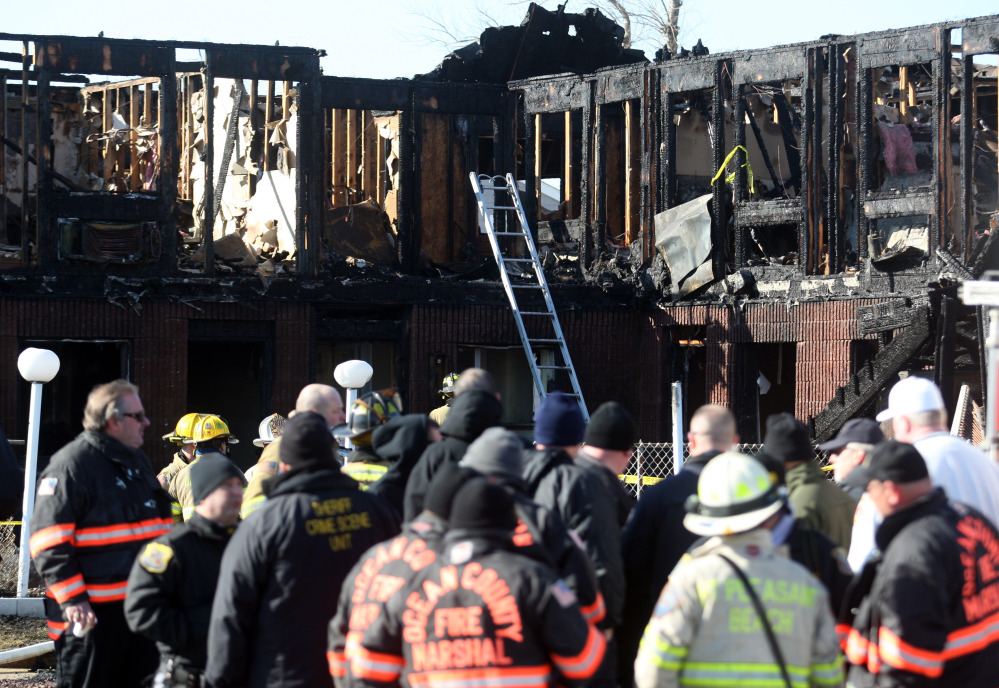 Firefighters investigate an early morning fire at the Mariner’s Cove Hotel in Point Pleasant Beach, N.J. on Friday.