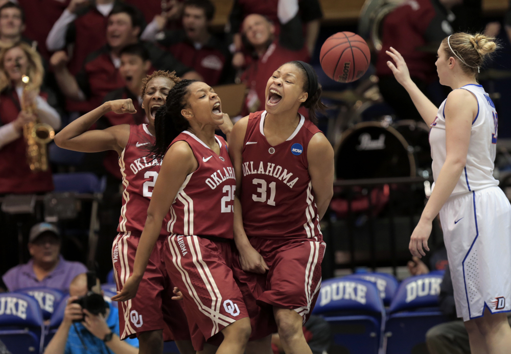 Oklahoma’s Portia Durrett (31) celebrates with teammates Sharane Campbell, left, and Gioya Carter, middle, while DePaul’s Megan Podkowa recovers the ball after Durrett scored and drew a foul that eventually pulled the Sooners within three points of DePaul during the second half of their first-round game in the NCAA basketball tournament in Durham, N.C., Saturday.