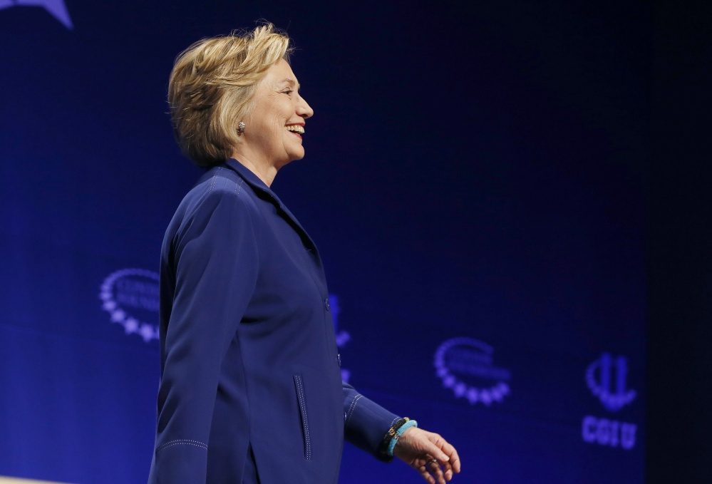 Former Secretary of State Hillary Rodham Clinton smiles as she walks on stage to give an address at a student conference for the Clinton Global Initiative University at Arizona State University on Friday in Tempe, Ariz.