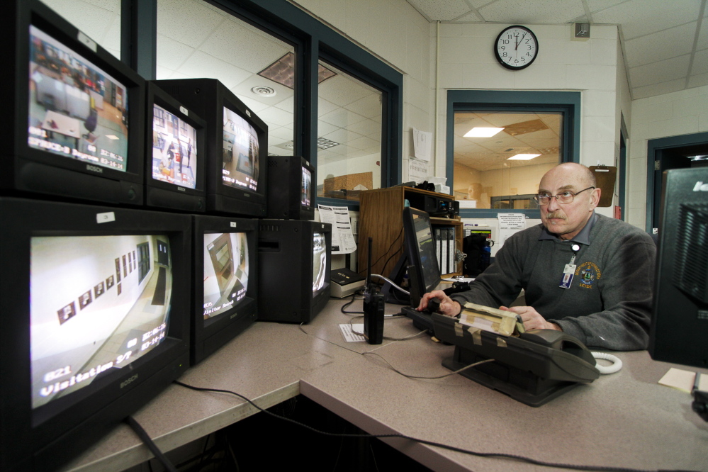 Juvenile Program Worker David Bailey monitors security cameras in the Central Control office at Long Creek Youth Development Center on March 14.
